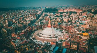Aerial view of Boudhanath Stupa surrounded by the city of Kathmandu.