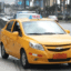 A local yellow Guayaquil taxi in the street.