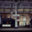 A platform at Newcastle Central Station with a white sign in the centre saying "Newcastle".