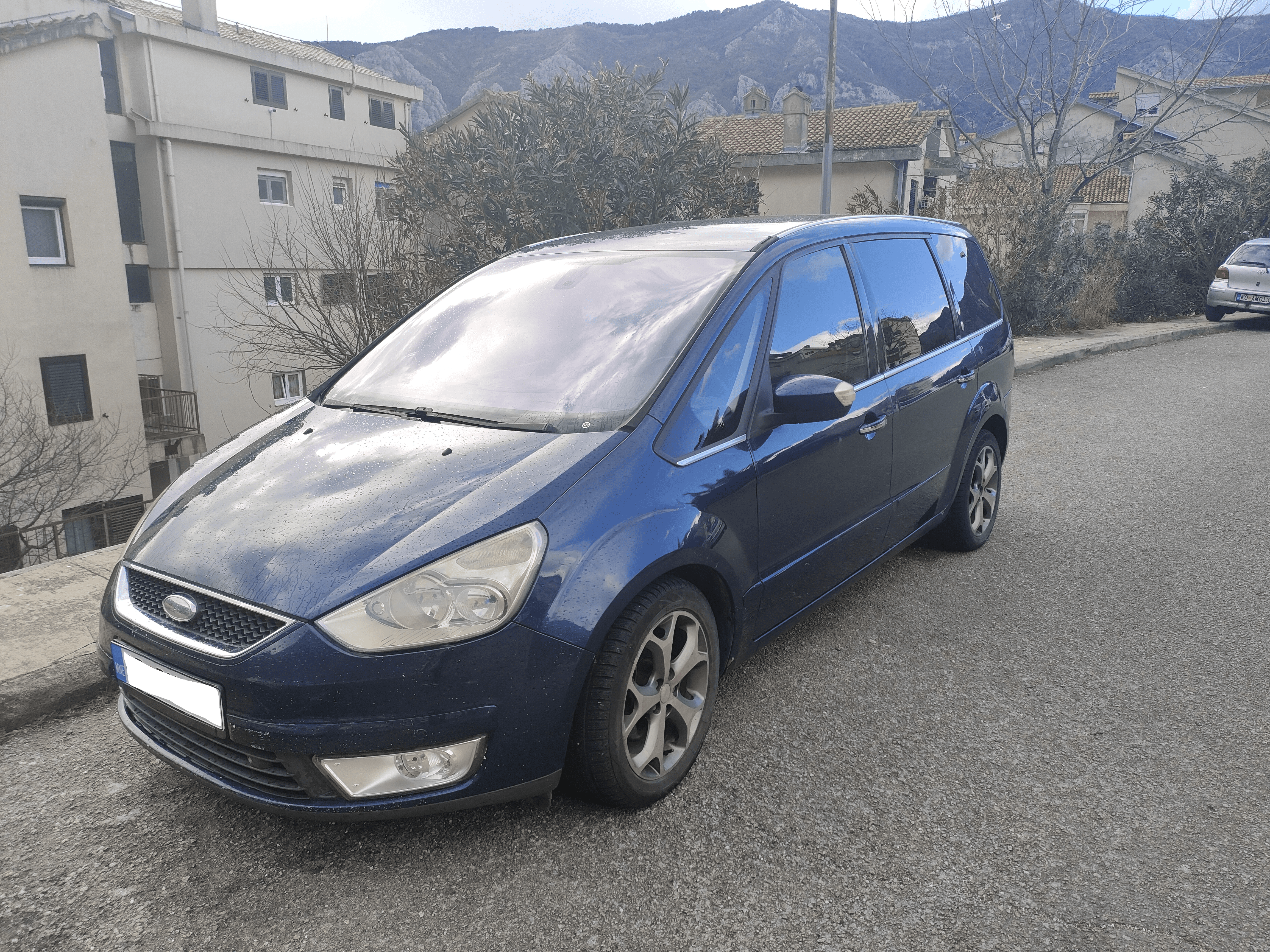 Tivat Airport Taxi (Sedan) Welcome pickups Blue Tivat Airport taxi parked on a quiet street in Tivat.