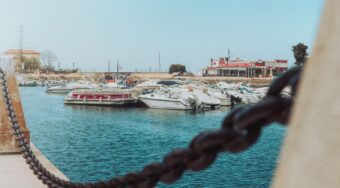 A view of Faro Marina in the city center with small boats anchored in the harbor.