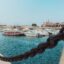 A view of Faro Marina in the city center with small boats anchored in the harbor.