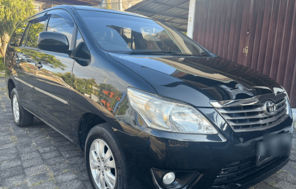 A black Bali Airport taxi (Minivan) for your transfer.