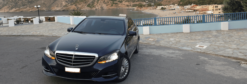 A black Crete Airport taxi (Sedan).