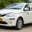 A white Jaipur Airport taxi.