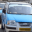 Blue Pune taxi services lined up in a street.