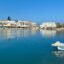 A view of Rethymno Harbour, surrounded by blue skies and water.
