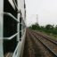 View from a train window of train tracks.