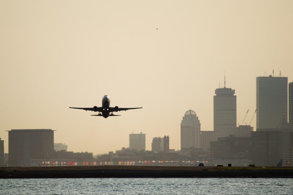 A plane flies over Boston.