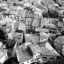 black and white photo of aerial view of clustered homes