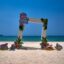 Picture of a man-made archway on Patong Beach, with blue skies and waters behind.