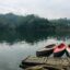 Three kayaks moored to a wooden pier.