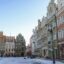 Colourful old buildings set around a snow covered open square