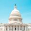 View of the front of the Capitol building in central Washington DC, with clear blue skies above.