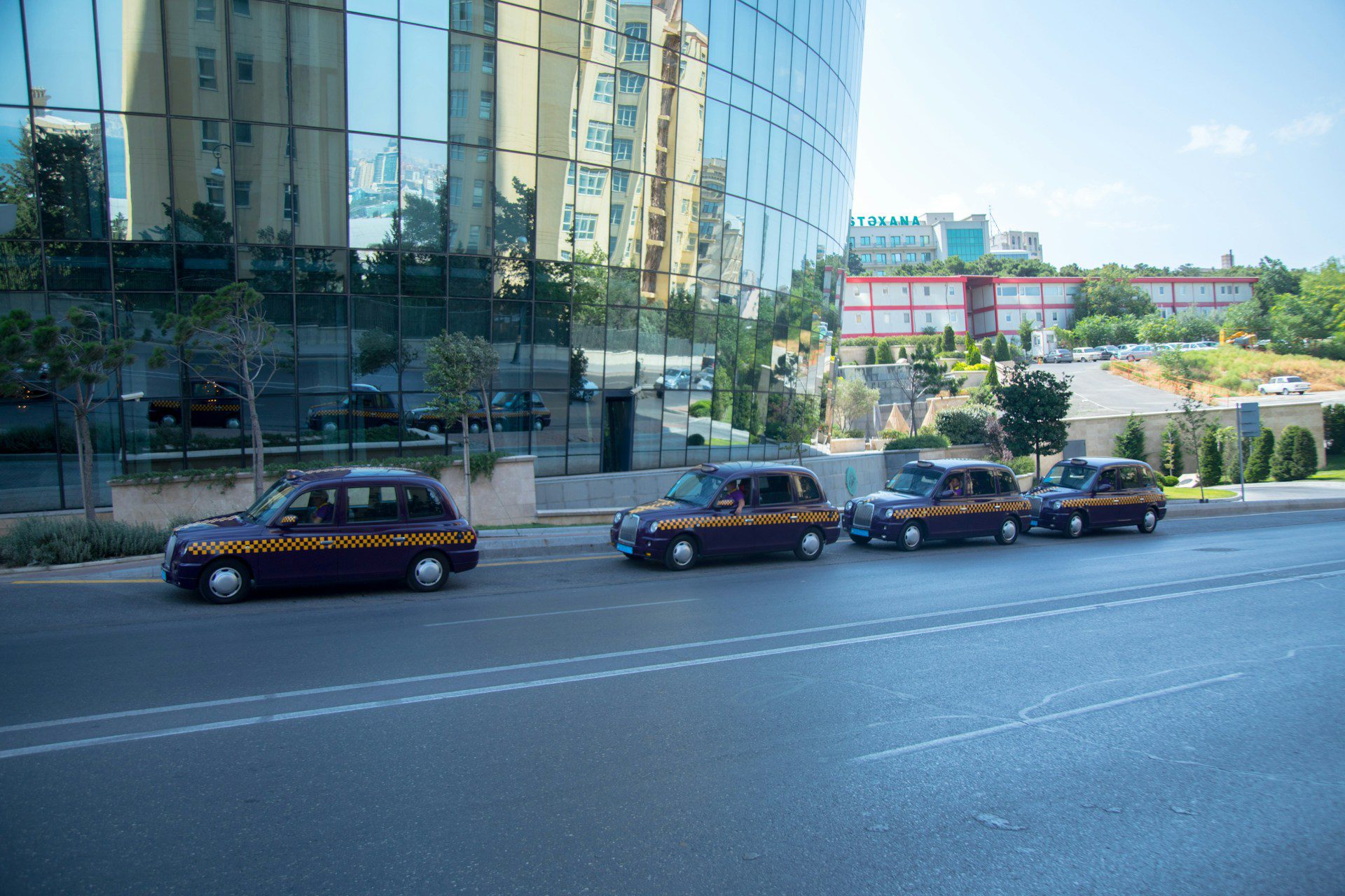 Purple Baku taxi - Welcome Pickups Purple Baku taxis lined up outside of a hotel in Baku city centre.