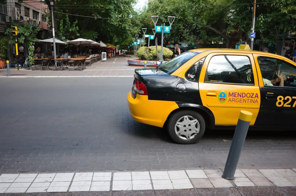Mendoza,,Argentina,-,January,,2020:,Black,And,Yellow,City,Taxi a red and yellow taxi in Mendoza argentina