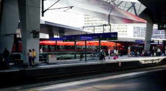 A platform at Vienna Hbf Station, with a sign reading "Wien Hauptbahnhof".