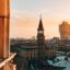 Duomo di Milano Italy, surrounded by rooftops at sunset.