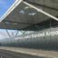 Stansted Airport main terminal building, with blue skies above.