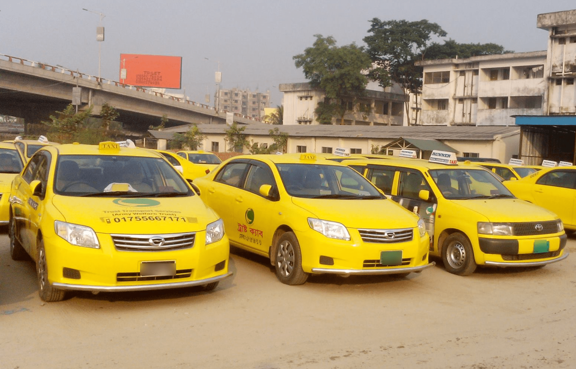 Dhaka Taxi Yellow Dhaka taxis parked and lined up.