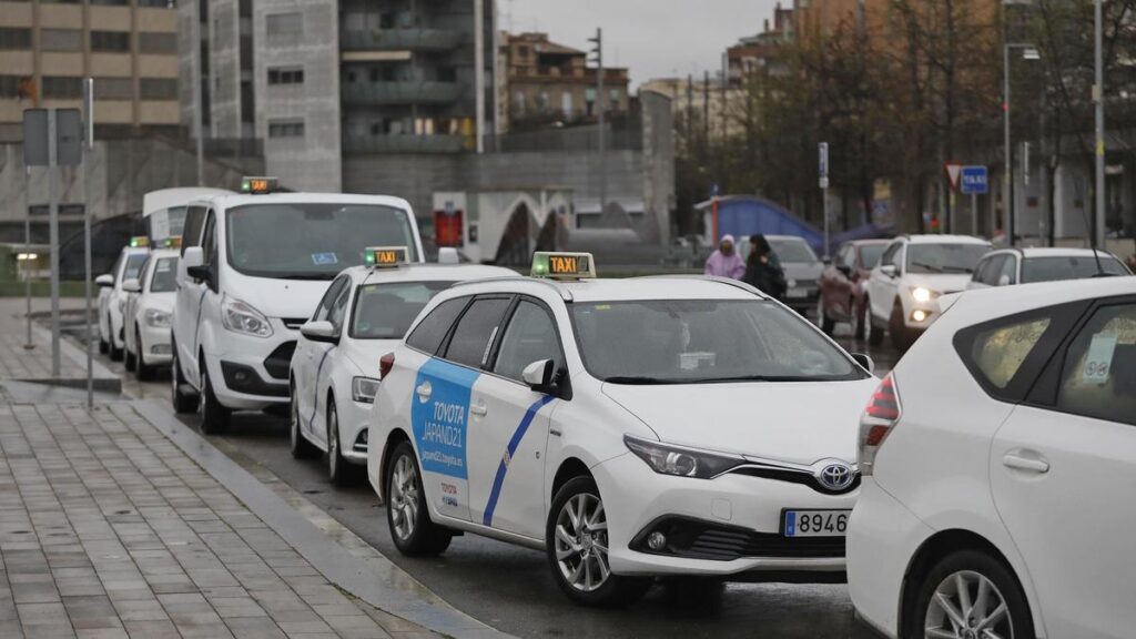 White taxis lined up in Girona.