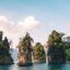 Trees and cliffs in the waters of Khao Sok National Park, Thailand.