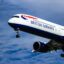 Image of a British Airways plane landing at Heathrow Airport, surrounded by blue skies.