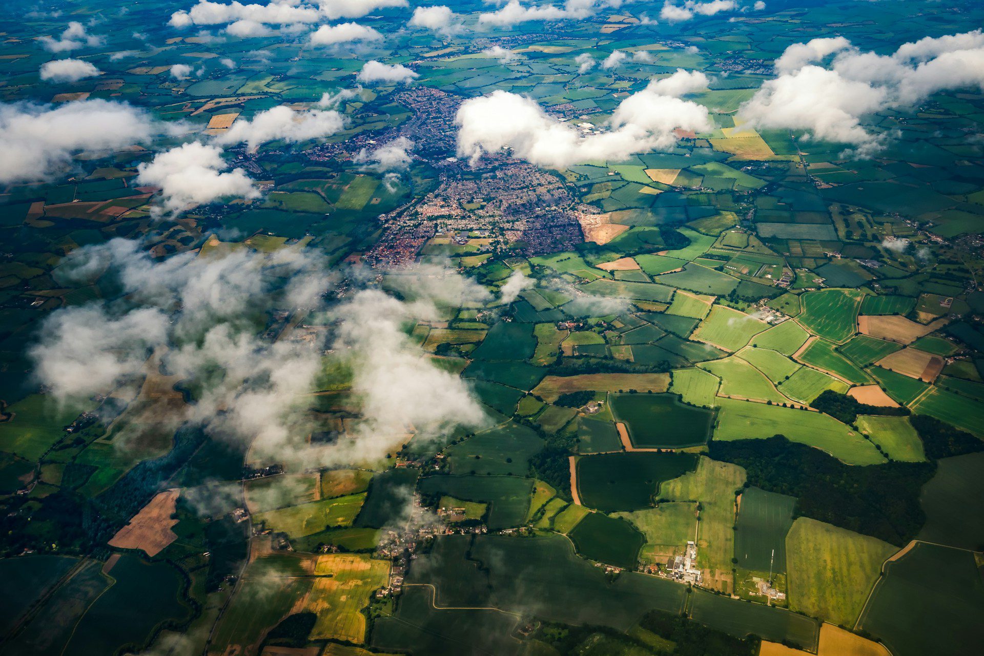 Aerial view of Stansted, showing green fields and buildings.