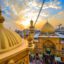 Beautiful buildings of Najaf, Iraq under a sun filled sky.