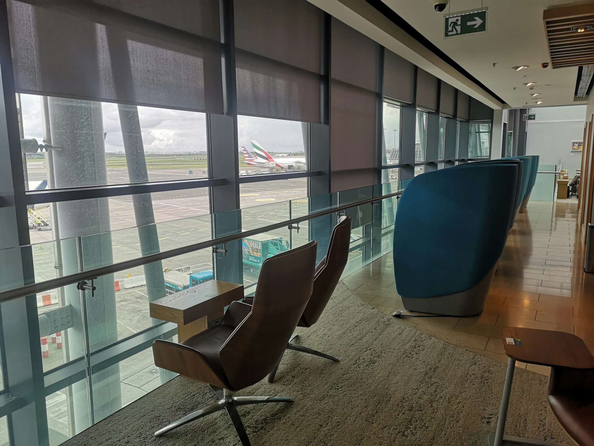 Comfortable chairs in a Dublin Airport lounge facing the runway.