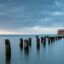 Old pier legs stick out of the water at Gdynia.