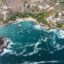 An aerial view of houses scattered around the coastline in Puerto Escondido.