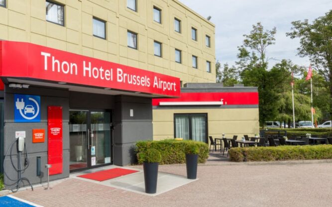 Front entrance view of the beige and red Thon Hotel Brussels Airport Hotel