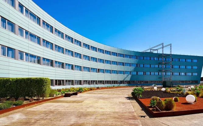 Exterior of Barcelona Airport Hotel, with blue skies above.