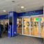 Entrance to London City Airport Terminal, with a blue rim around the doors saying Welcome.