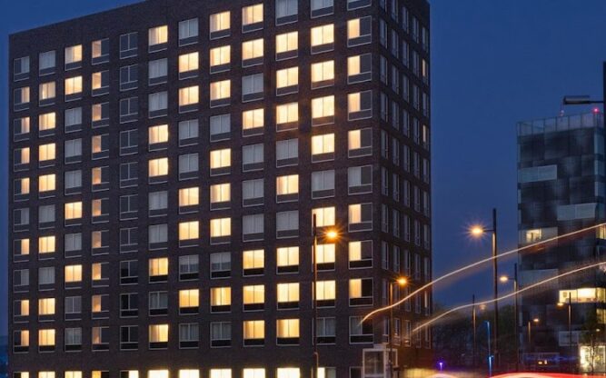 Lit windows of Holiday Inn by Eindhoven Airport at night