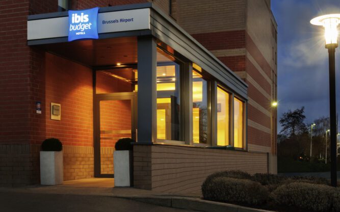 The front entrance to the ibis budget Brussels Airport Hotel lit up at night