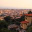 A hazy view from a mountainside vantage point of Lamezia Terme city filled with houses.