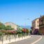 Street and homes under a blue sky in Figari.