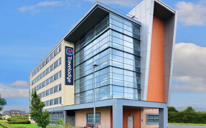 A view of the Travelodge Liverpool John Lennon Airport Hotel comprised of three different building facades.