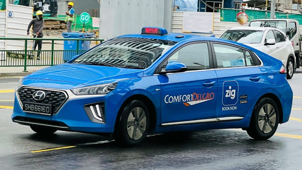 A blue taxi on the streets of Singapore