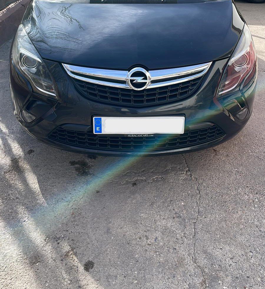 A black Dublin Airport taxi sedan parked in a car park.