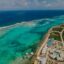 An aerial view of a beautiful beach with turquoise waters in Grand Cayman.