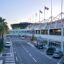 An outside view of Nice Airport, France, showing the terminal lined with palm trees.