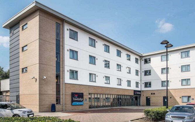 The brown brick and white Travelodge Edinburgh Airport Hotel