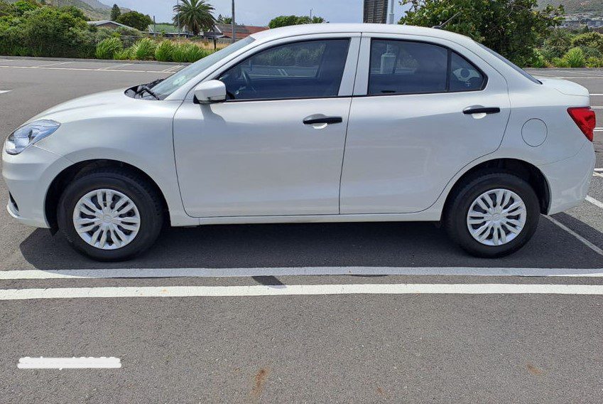 Taxi Cape Town Airport (Sedan) - Welcome Pickups Side view of a white Cape Town Airport taxi sedan parked in an outdoor parking space.
