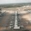 Planes at Las Vegas Airport lined up in 4 parallel rows of aircraft gates.