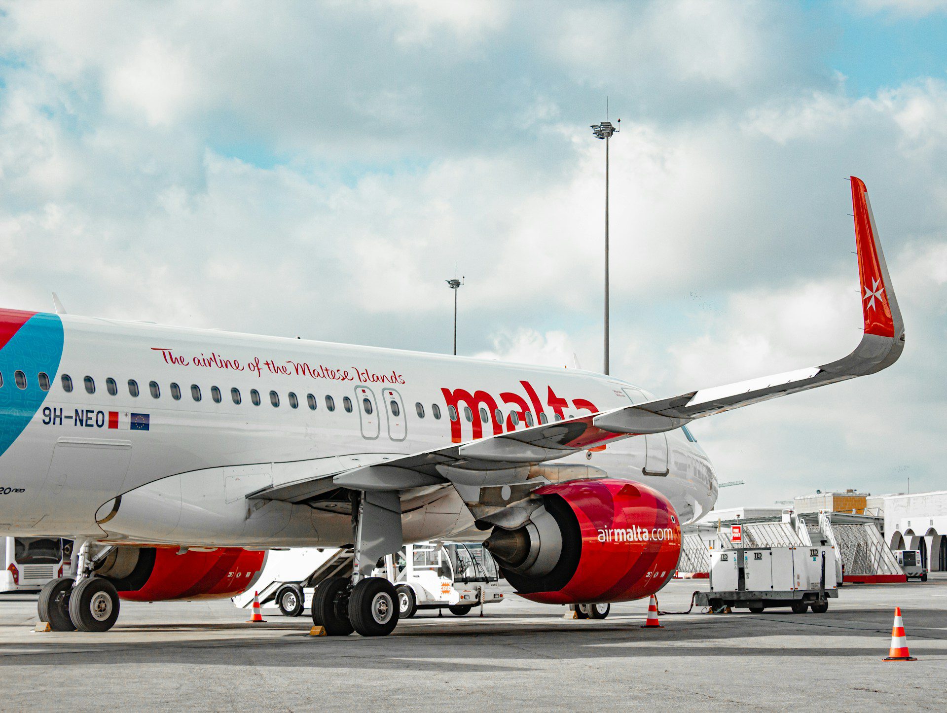 A Maltese national airline plane on the runway at Malta Airport.