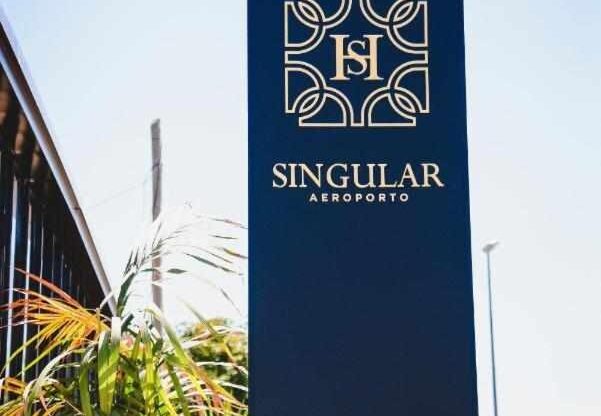 The blue Singular Hotel Porto Airport sign out the front of the hotel building.