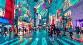Shopping facilities along a street in Tokyo with pedestrians walking.